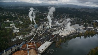 AX153_151E - 5.5K aerial stock footage flying by the Georgia Pacific Paper Mill in Camas, Washington