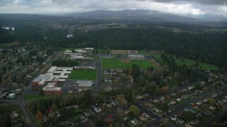 AX153_155 - 5.5K stock footage aerial video approaching school campus and sports fields in Camas, Washington
