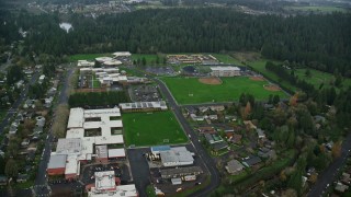 AX153_155E - 5.5K aerial stock footage approaching school campus and sports fields in Camas, Washington