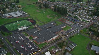 AX153_166E - 5.5K aerial stock footage orbiting Washougal High School and football field in Washougal, Washington