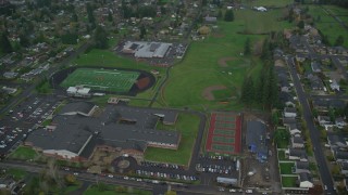 AX153_168 - 5.5K aerial stock footage orbiting an elementary school and high school in Washougal, Washington