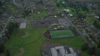 AX153_170 - 5.5K stock footage aerial video orbiting Washougal High School and sports fields in Washougal, Washington