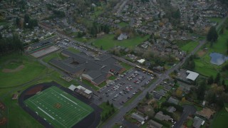 AX153_171 - 5.5K aerial stock footage of a bird's eye view of Washougal High School, suburban homes, and Orchard Hills Golf Club in Washougal, Washington
