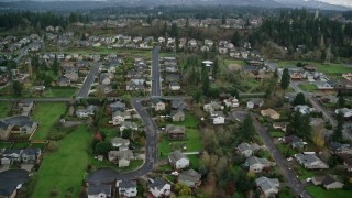 AX153_173E - 5.5K aerial stock footage approaching and flying over Washougal High School and sports fields in Washougal, Washington