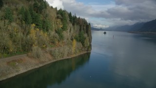 AX154_005 - 5.5K aerial stock footage approaching train tracks and tunnel in the Columbia River Gorge, Oregon