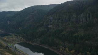 AX154_017E - 5.5K aerial stock footage approaching a waterfall on a Columbia River Gorge cliff in Multnomah County, Oregon