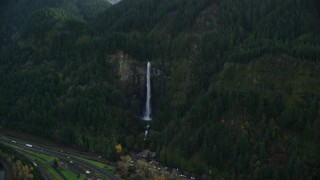 AX154_019E - 5.5K aerial stock footage approaching Multnomah Falls on a Columbia River Gorge cliff face in Multnomah County, Oregon