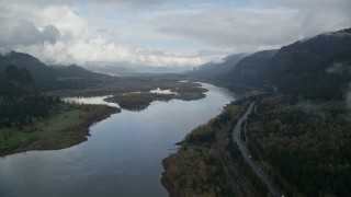 AX154_024E - 5.5K aerial stock footage following the river and I-84 toward islands in the Columbia River Gorge
