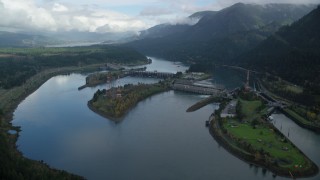 AX154_029 - 5.5K stock footage aerial video flying by the Bonneville Dam in Columbia River Gorge