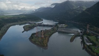 AX154_029E - 5.5K aerial stock footage flying by the Bonneville Dam in Columbia River Gorge