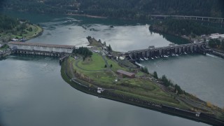 AX154_031 - 5.5K aerial stock footage orbiting of Bonneville Dam in Columbia River Gorge