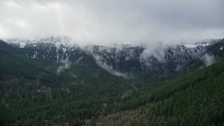 AX154_057 - 5.5K aerial stock footage of snowy mountains at the end of a canyon with evergreen trees in Cascade Range, Hood River County, Oregon