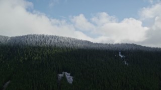 AX154_058 - 5.5K aerial stock footage approaching the snow line and snowy evergreen trees atop a mountain ridge, Cascade Range, Hood River County, Oregon