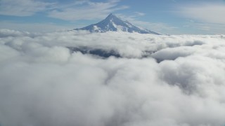 AX154_066 - 5.5K aerial stock footage approaching snowy summit while flying over clouds, Mount Hood, Cascade Range, Oregon