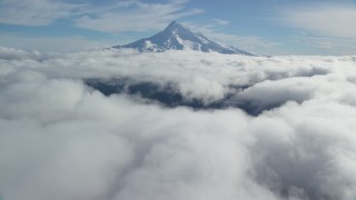 AX154_067 - 5.5K stock footage aerial video approaching Mount Hood summit with snow and fly over clouds, Mount Hood, Cascade Range, Oregon