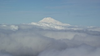 AX154_069 - 5.5K aerial stock footage of Mt Adams' snowy summit in the distance and low cloud cover, Mount Adams, Cascade Range, Oregon