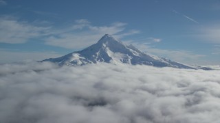 AX154_070 - 5.5K aerial stock footage of the summit of Mount Hood with snow and low clouds, Mount Hood, Cascade Range, Oregon