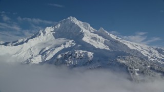 AX154_078E - 5.5K aerial stock footage of snow-covered Mount Hood, Cascade Range, Oregon
