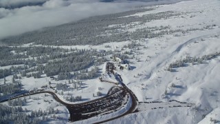 AX154_092 - 5.5K aerial stock footage orbiting Timberline Lodge and snowy forest on Mount Hood, Cascade Range, Oregon