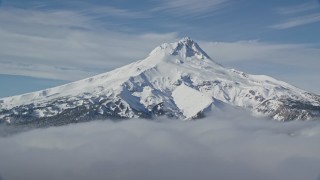 AX154_110 - 5.5K aerial stock footage of low clouds and Mount Hood, Cascade Range, Oregon