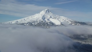 AX154_116 - 5.5K stock footage aerial video of snow-capped peak surrounded by low clouds, Mount Hood, Cascade Range, Oregon