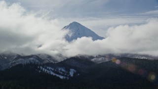 AX154_131E - 5.5K aerial stock footage of clouds around the snowy summit of Mount Hood, Cascade Range, Oregon