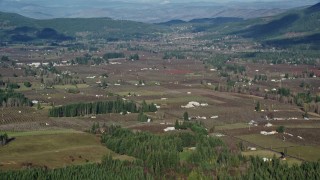 AX154_136E - 5.5K aerial stock footage approaching farms and farmland in Parkdale, Oregon