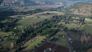 AX154_141E - 5.5K aerial stock footage flying over farms in Parkdale, Oregon