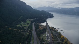 AX154_161E - 5.5K aerial stock footage flying over light traffic on Interstate 84 in Columbia River Gorge