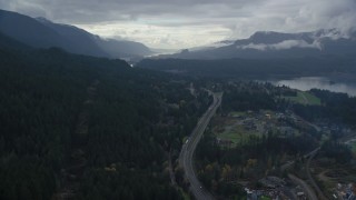 AX154_167 - 5.5K aerial stock footage flying over I-84 and forest beside Cascade Locks, Oregon in Columbia River Gorge