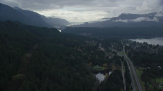 AX154_168 - 5.5K aerial stock footage flying over forest by Interstate 84, Cascade Locks, Oregon in Columbia River Gorge