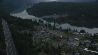 AX154_171 - 5.5K aerial stock footage flying over Interstate 84 and small town RV park to approach the Bridge of the Gods, Cascade Locks, Oregon in Columbia River Gorge