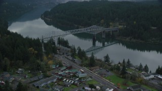 AX154_172 - 5.5K aerial stock footage flying over small town RV park and hotel to approach the Bridge of the Gods, Cascade Locks, Oregon in Columbia River Gorge