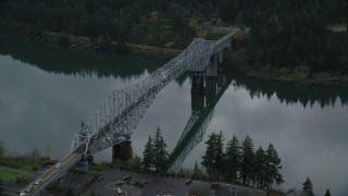 AX154_173 - 5.5K aerial stock footage of Traffic crossing Bridge of the Gods in Cascade Locks, Columbia River Gorge, Oregon