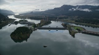AX154_175E - 5.5K aerial stock footage approaching the Bonneville Dam in the Columbia River Gorge