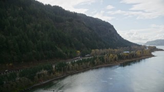 AX154_189 - 5.5K aerial stock footage approaching the I-84 highway and reveal Multnomah Falls on a cliff face of the Columbia River Gorge