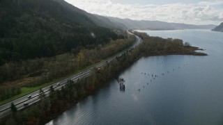 AX154_190E - 5.5K aerial stock footage flying by Interstate 84 highway with light traffic on the Oregon side of Columbia River Gorge