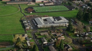 AX154_205 - 5.5K stock footage aerial video orbiting Gause Elementary and the Washougal High School football and baseball fields in Washougal, Washington