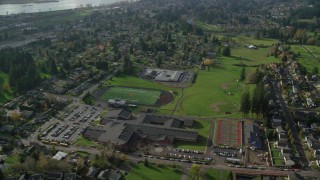 AX154_207 - 5.5K stock footage aerial video orbiting Gause Elementary, Washougal High School and sports fields in Washougal, Washington