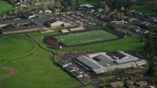AX154_209 - 5.5K aerial stock footage flying away from Gause Elementary, Washougal High School, and sports fields in Washougal, Washington