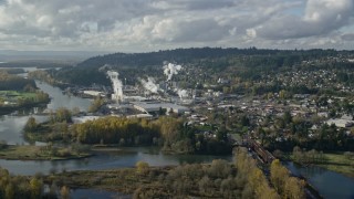 AX154_210E - 5.5K aerial stock footage approaching Washougal River and the Georgia Pacific Paper Mill in Camas, Washington