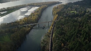 AX154_214 - 5.5K aerial stock footage tracking a barge and the Highway 14 bridge over Columbia River to Lady Island, Vancouver, Washington