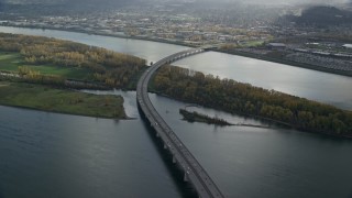 AX154_218E - 5.5K aerial stock footage of I-205 Bridge and the Columbia River with godrays shining down, Vancouver, Washington