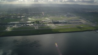AX154_220 - 5.5K aerial stock footage of godrays shining down on the Portland International Airport, approach from the Columbia River