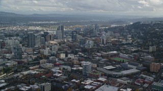 AX154_229E - 5.5K aerial stock footage of skyscrapers seen from Providence Park in Downtown Portland, Oregon