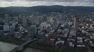 AX154_235E - 5.5K aerial stock footage orbiting skyscrapers in Downtown Portland, Oregon, seen from across the Willamette River