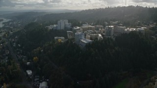 AX154_246E - 5.5K aerial stock footage approach and flyby the Oregon Health and Science University complex in the hills over Portland, Oregon