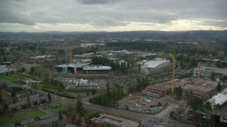 AX155_010 - 5.5K aerial stock footage of Nike Headquarters office buildings with construction cranes, Beaverton, Oregon