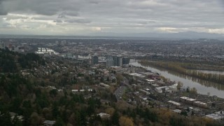 AX155_018E - 5.5K aerial stock footage flying by hillside homes to reveal condo high-rises by the Willamette River in South Waterfront, Portland, Oregon