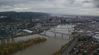 AX155_024 - 5.5K aerial stock footage flying by Ross Island Bridge near Downtown Portland, Oregon, and South Waterfront condo high-rises